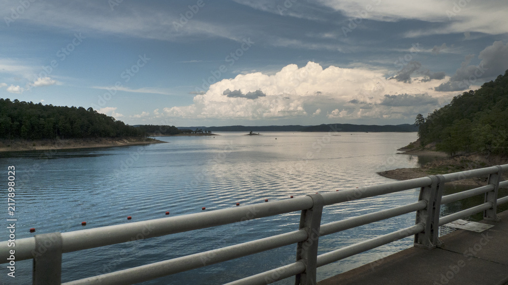 Beautiful lake view of storm clouds and mountains, drive over dam