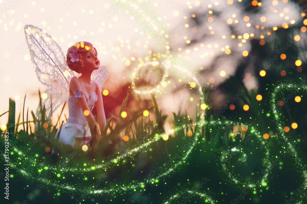 image of magical little fairy in the forest at sunset.