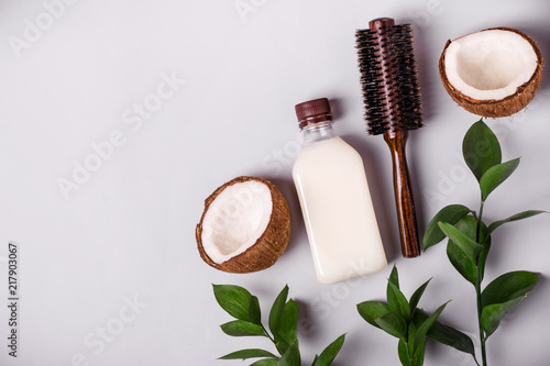 Coconut oil and tropical leaves. Hair care spa concept. Toned