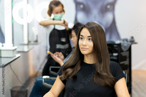 Portrait of beautiful mixed race young girl with long smooth hair in salon.