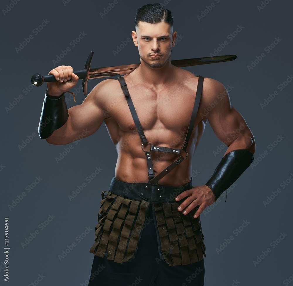 Brutal ancient Greece warrior with a muscular body in battle uniforms Brutal ancient Greece warrior with a muscular body in battle uniforms