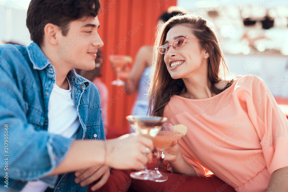 Outgoing girl and smiling man speaking while tasting delicious beverage. Happy couple during rest concept Outgoing girl and smiling man speaking while tasting delicious beverage. Happy couple during rest concept