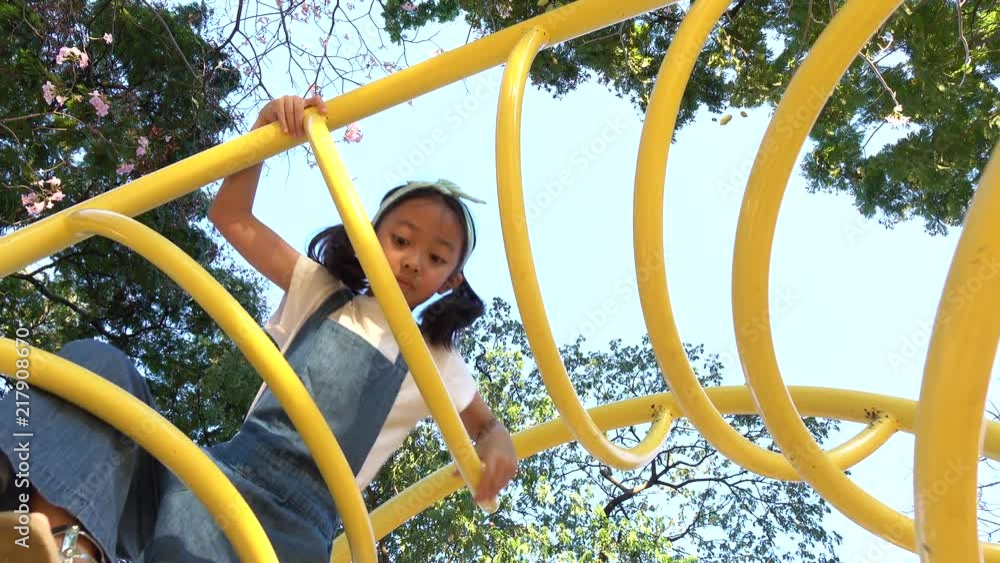 Happy little girl playing at public playground Happy little girl playing at public playground