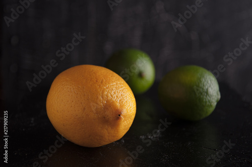 Lemon, lime on a black background.