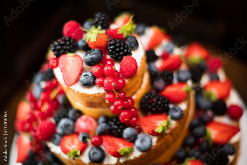 Multi tiered sponge and cream wedding cake decorated with fruit