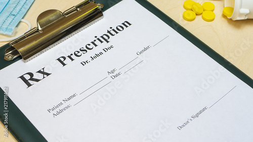 Prescription for tablet pills or drugs with bottle and yellow tablets or pills and medical mask
