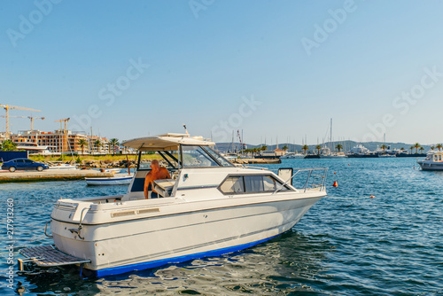 TIVAT, MONTENEGRO - JULY 16, 2018: man on boat in buy of montenegro port. summer time