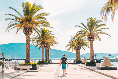 man walking by pier in summer day © phpetrunina14