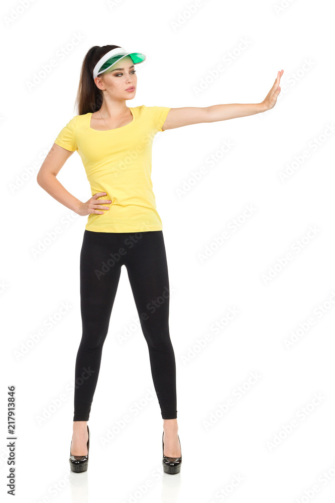 Young Woman In Yellow Shirt Is Holding Hand Raised