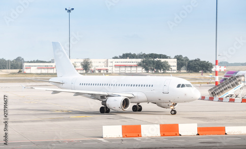 The white plane at the airport taxiway, airline transportation concept