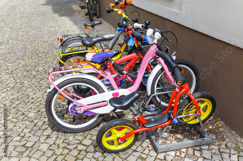 kids bicycles parked at parking spot in the city