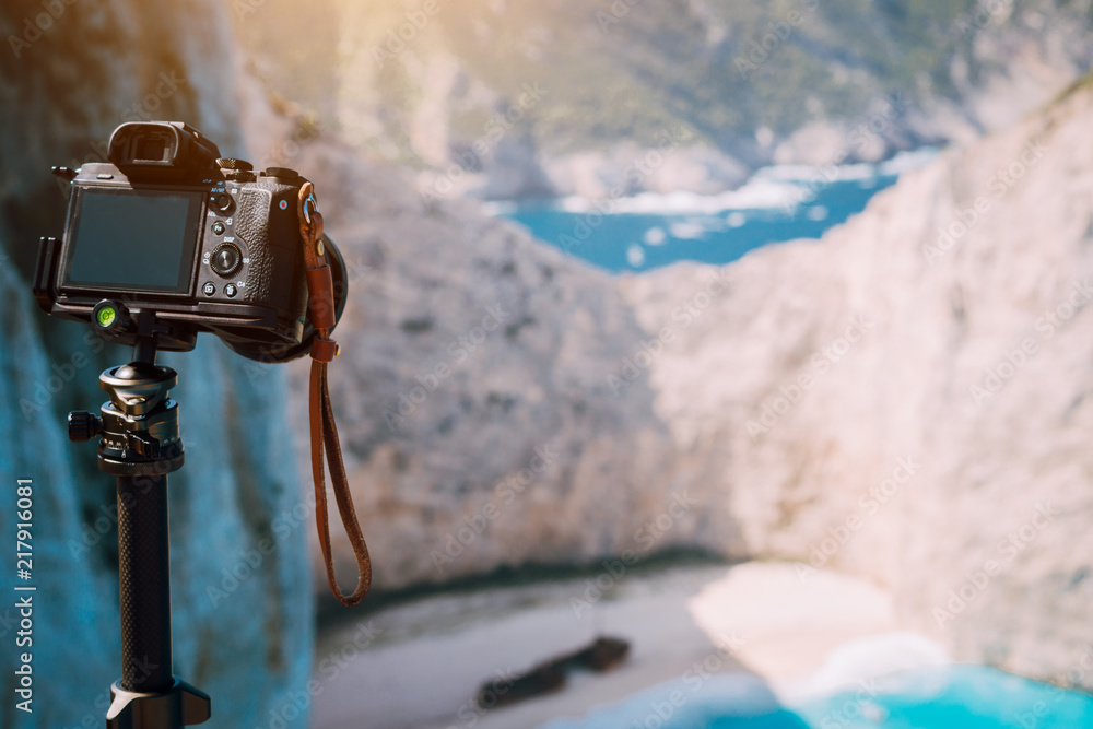 Digital photo camera on tripod focused on Shipwreck in Navagio beach in  morning sun light. Famous visiting landmark location on Zakynthos island,  Greece Stock Photo | Adobe Stock