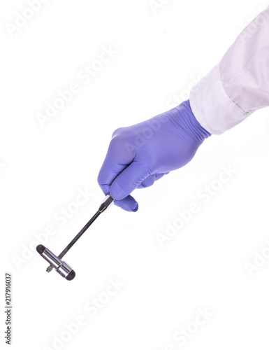 hand of the medic with a hammer on a white background