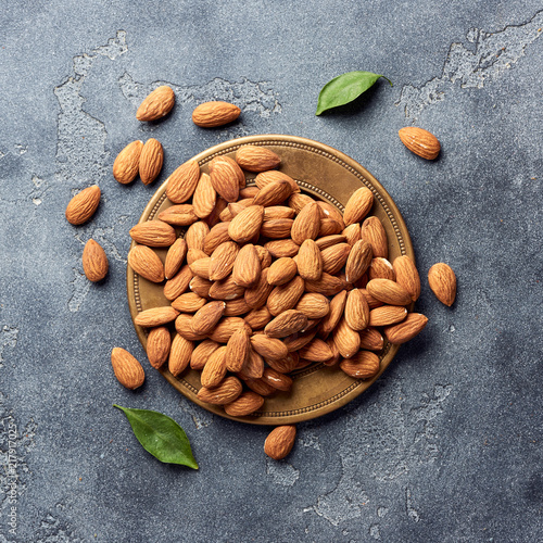 Almond nuts on gray concrete background. Top view.