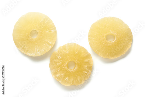Sweet dried pineapple rings isolated on white background. Top view of candied sliced fruits.