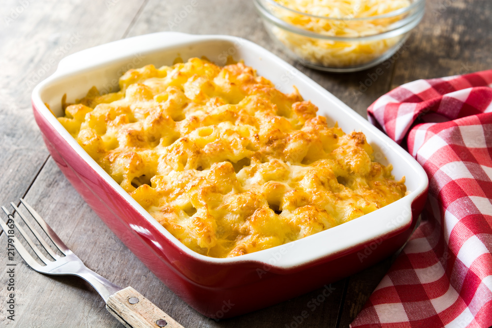 Typical American macaroni and cheese on wooden table Typical American macaroni and cheese on wooden table
