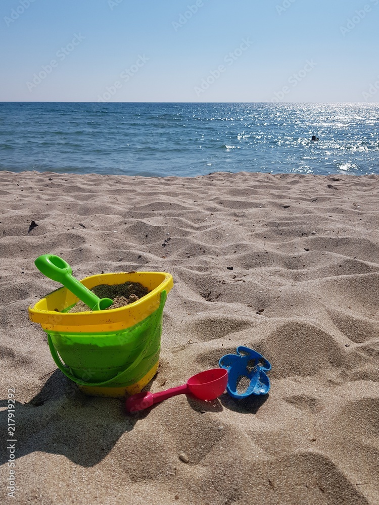 children's toys on the beach with white sand on a sunny daychildren's toys on the beach with white sand on a sunny day children's toys on the beach with white sand on a sunny daychildren's toys on the beach with white sand on a sunny day