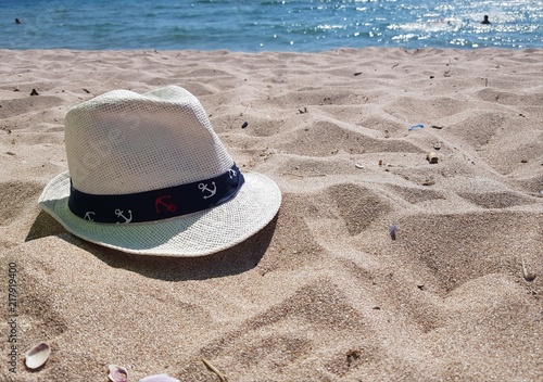 hat on the beach with white sand on a sunny day