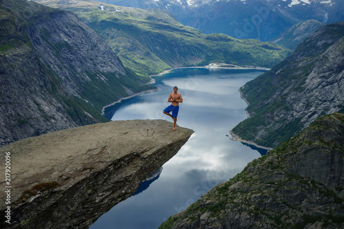 Yog is praying on the edge Trolltunga. Norway