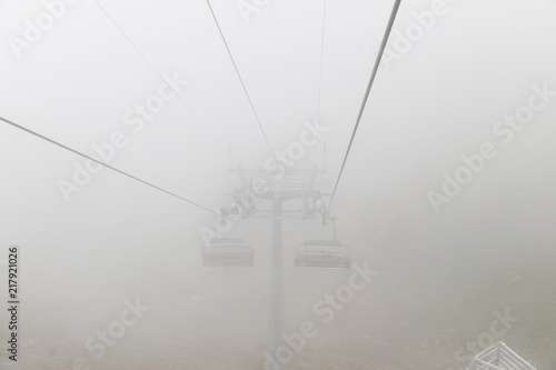 Aibga Ridge. Mountain Kamennyy stolb. 2509m. Mountains near the ski resort. cable car on the mountain going into the fog and clouds photo