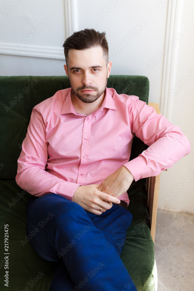 Young stylishly dressed groom on a wedding day. Wedding day. Man in stylish shirt. Shallow focus and some noise. Young stylishly dressed groom on a wedding day. Wedding day. Man in stylish shirt. Shallow focus and some noise.