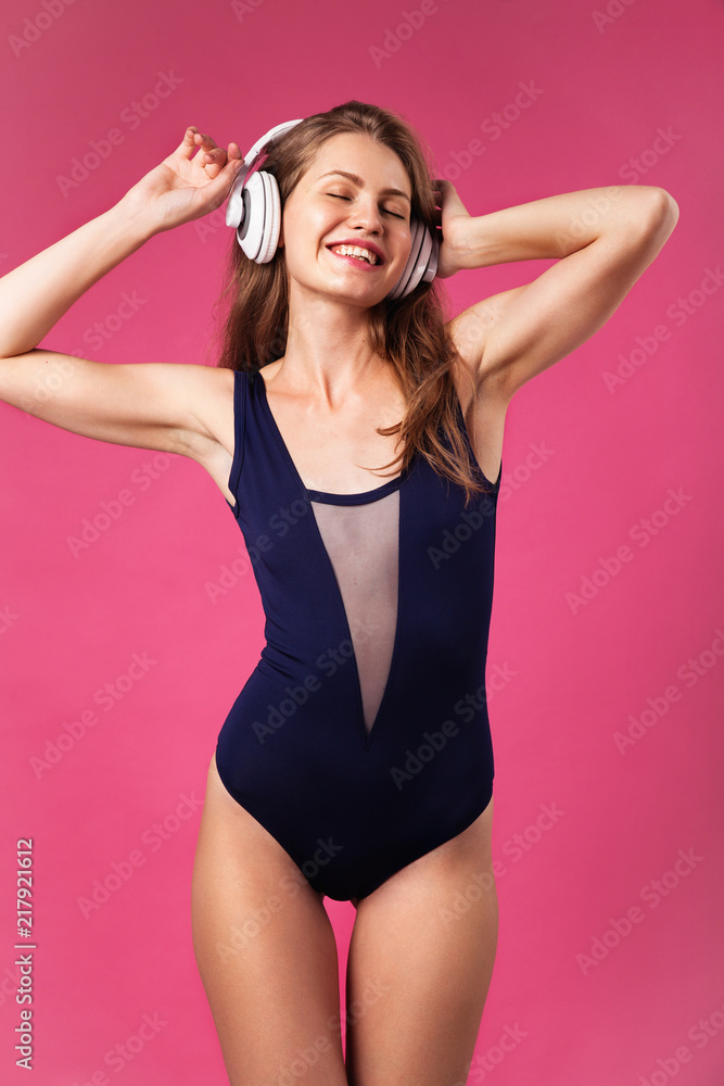 Obraz premium Beautiful joyful woman wearing big white headphones