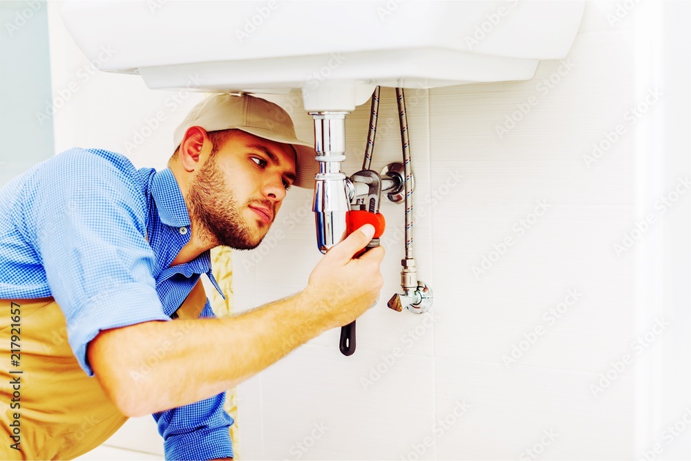 Hands of Professional plumber fixing pipes. Plumbing repair Hands of Professional plumber fixing pipes. Plumbing repair
