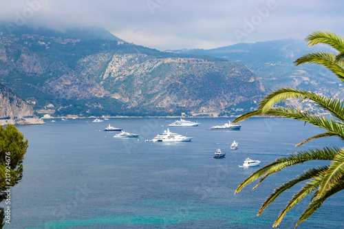 Saint-Jean-Cap-Ferrat and Espalmador Bay with yachts and tourist boats in summer. Cote de Azur, French Riviera (PACA Region).