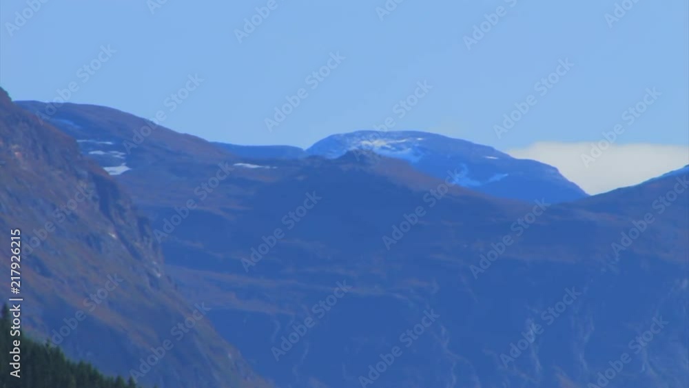 Dramatic mountain landscape from forest to snow capped peaks. PAN RIGHT. Dramatic mountain landscape from forest to snow capped peaks. PAN RIGHT.