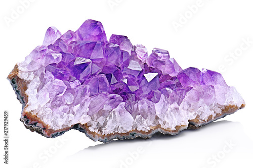 Violet Crystal Stone macro mineral. Purple rough Amethyst quartz crystals geode on white background, Uruguay photo