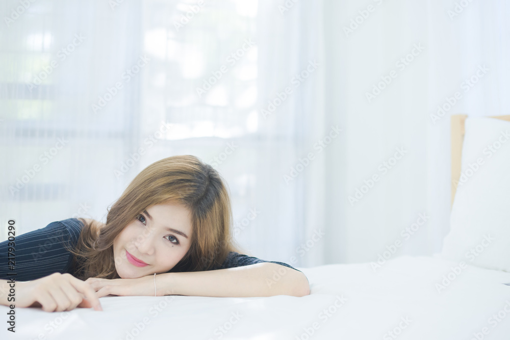 Beauty fashion portrait. Smiling young woman in bedroom. Close up Portrait of a beautiful Asian girl