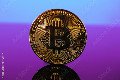 Bitcoin money crypto currency coin on reflective colorful background