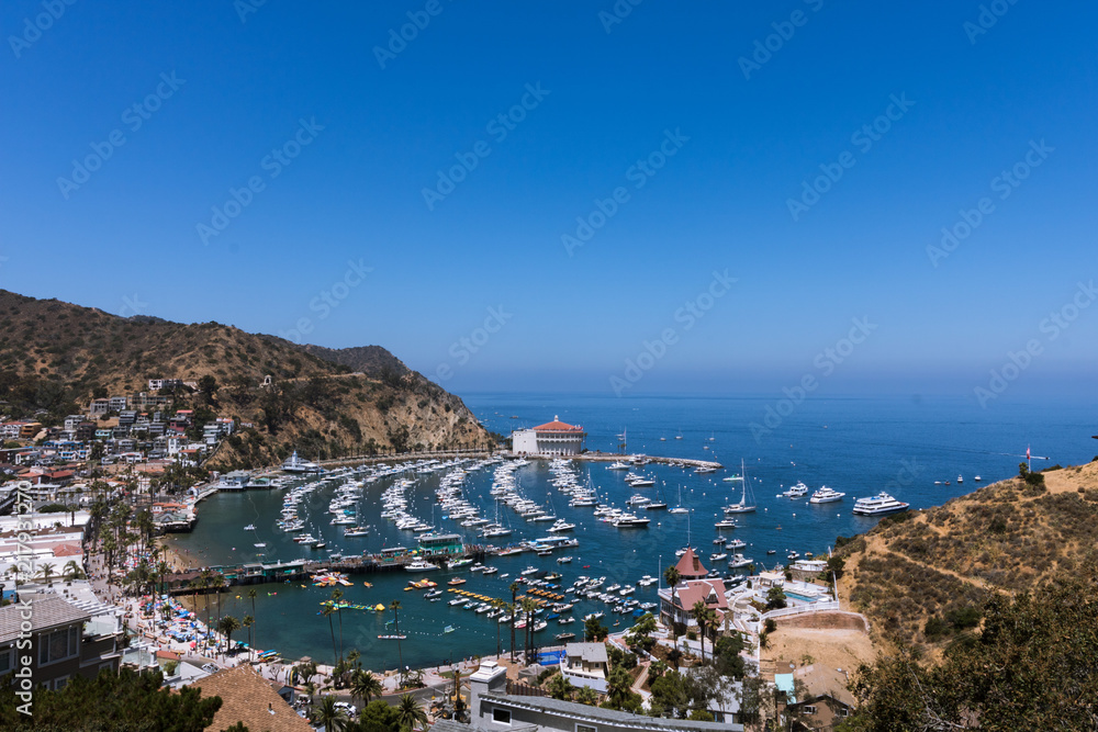 Overhead wide angle bay view of Avalon harbor with casino, pleasure pier, sailboats and yachts on Santa Catalina island vacation in California, USA luxury leisure vacation