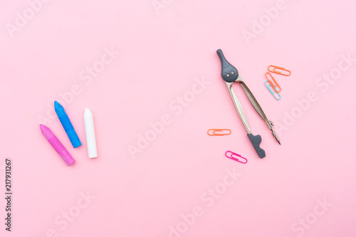 Back to school styled school supplies on pink background with copy space