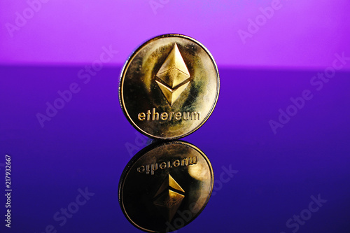 Etherum money crypto currency coin on reflective colorful background