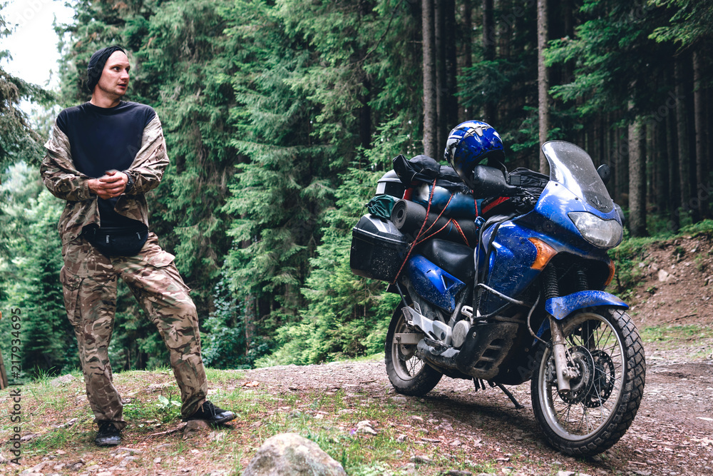 Motorcyclist man and Adventure Motorbike with beautiful mountains pine forest. Motorcycle trip. off road Traveling, Lifestyle Travel vacations sport outdoor concept. Motorcyclist man and Adventure Motorbike with beautiful mountains pine forest. Motorcycle trip. off road Traveling, Lifestyle Travel vacations sport outdoor concept.