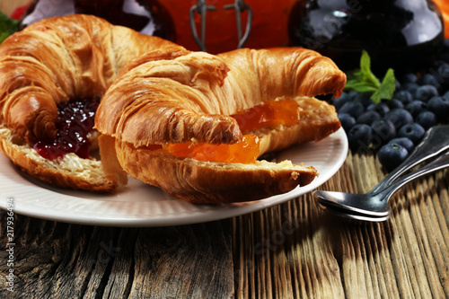 croissants with marmalade and assortment of jams, seasonal berries, apricot, mint and fruits