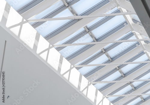 White metal construction of the glass roof of a large shopping center. Abstract high-tech architecture background photo
