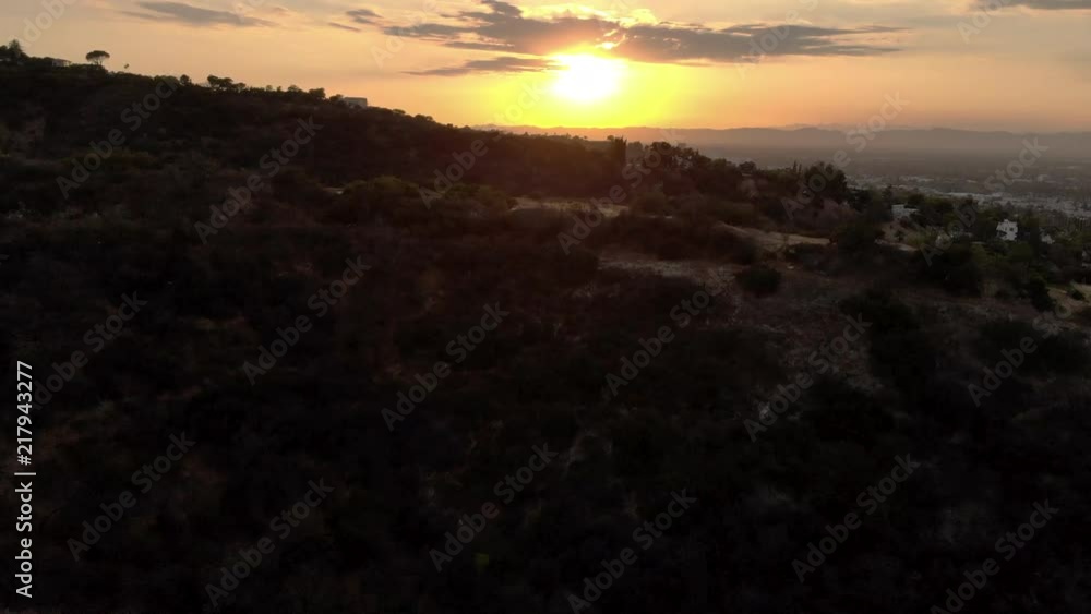 Aerial flyover of the Hollywood Hills looking at the San Fernando Valley during sunset. Aerial flyover of the Hollywood Hills looking at the San Fernando Valley during sunset.