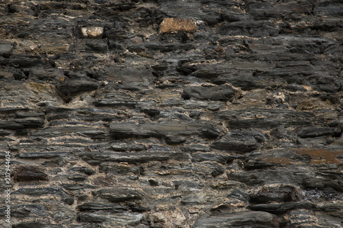 Decor texture with the structure of grew-brown stone wall 