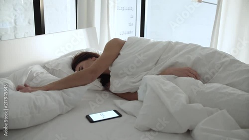 Alarm Clock On Phone. Woman Sleeping In Bed And Waking Up