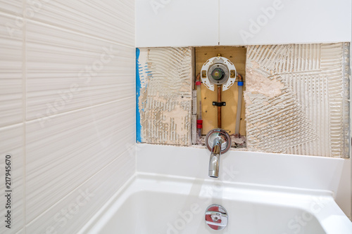 Faucet repair in the bathroom. Broken shower faucet plumbing job.