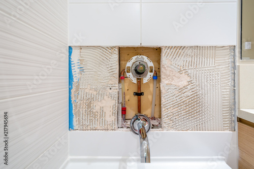 Faucet repair in the bathroom. Broken shower faucet plumbing job.