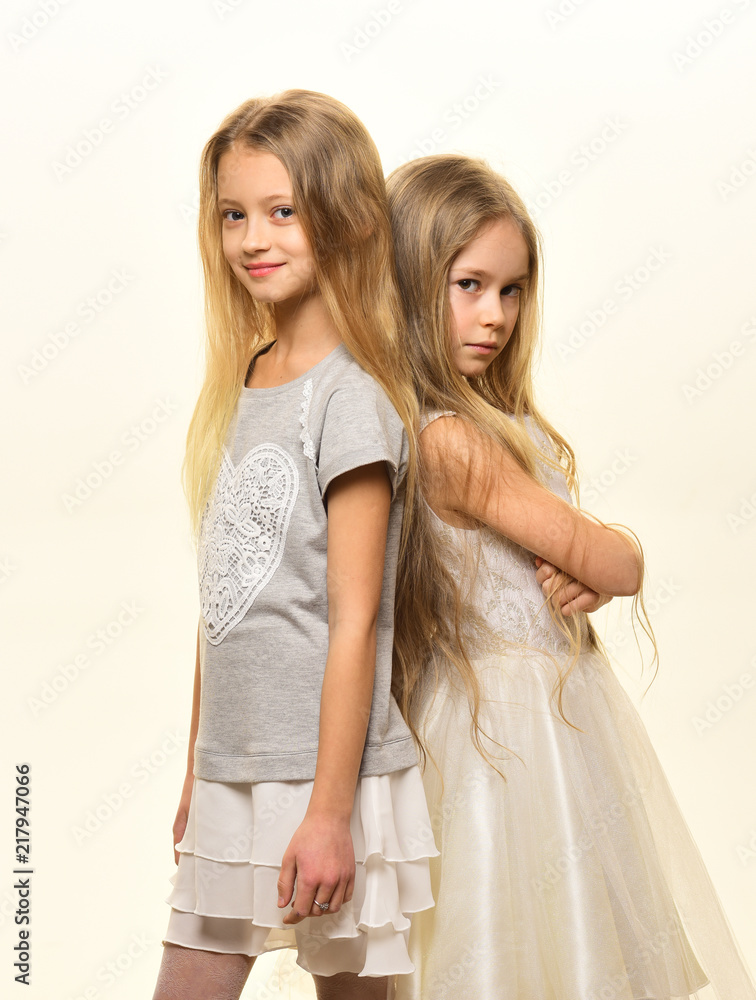 kid fashion. two small girls follow kid fashion. kid fashion with pretty sisters. kid fashion for girls in fashionable clothes