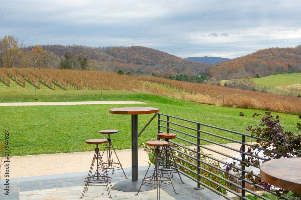 View from the open patio restaurant to winery and mountains with autumn fall foliage forest. View from the open patio restaurant to winery and mountains with autumn fall foliage forest.