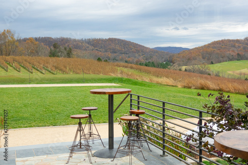 View from the open patio restaurant to winery and mountains with autumn fall foliage forest.