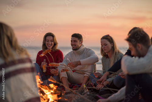 Group Of Young Friends Sitting By The Fire at beach © .shock