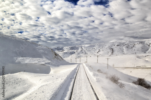 Snowy railway landscape. Cloudy weather.