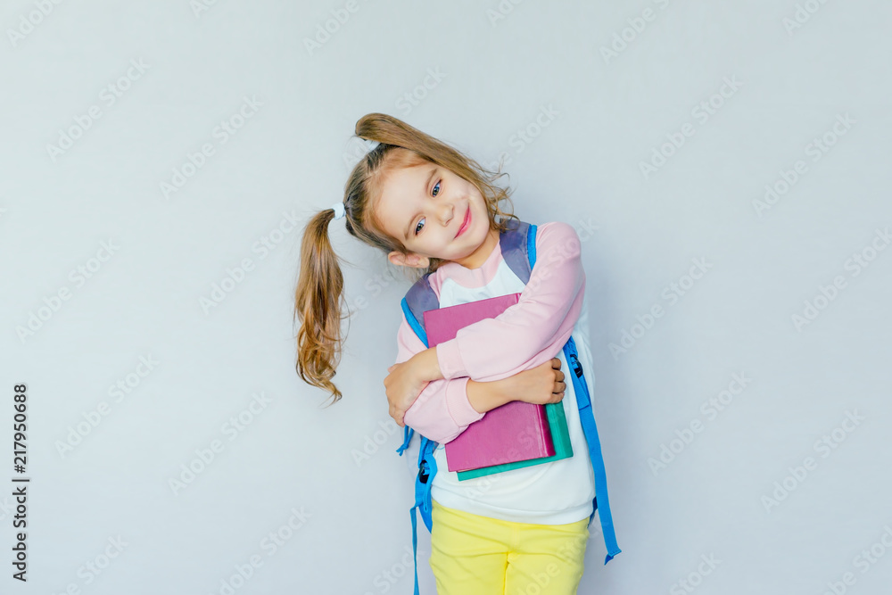 back to school. funny little girl from elementary school with a book and a bag. education. child with a book. place for your text. selective focus. concept of education. back to school. funny little girl from elementary school with a book and a bag. education. child with a book. place for your text. selective focus. concept of education.