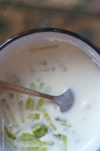 Summer cold soup. Okroshka. Preparing cold soup with fresh herbs.